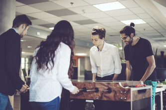 workers playing table football